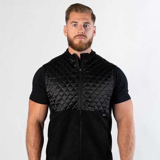 Confident bearded man looking at camera wearing zipped Aion Boardroom Recovery Vest in black