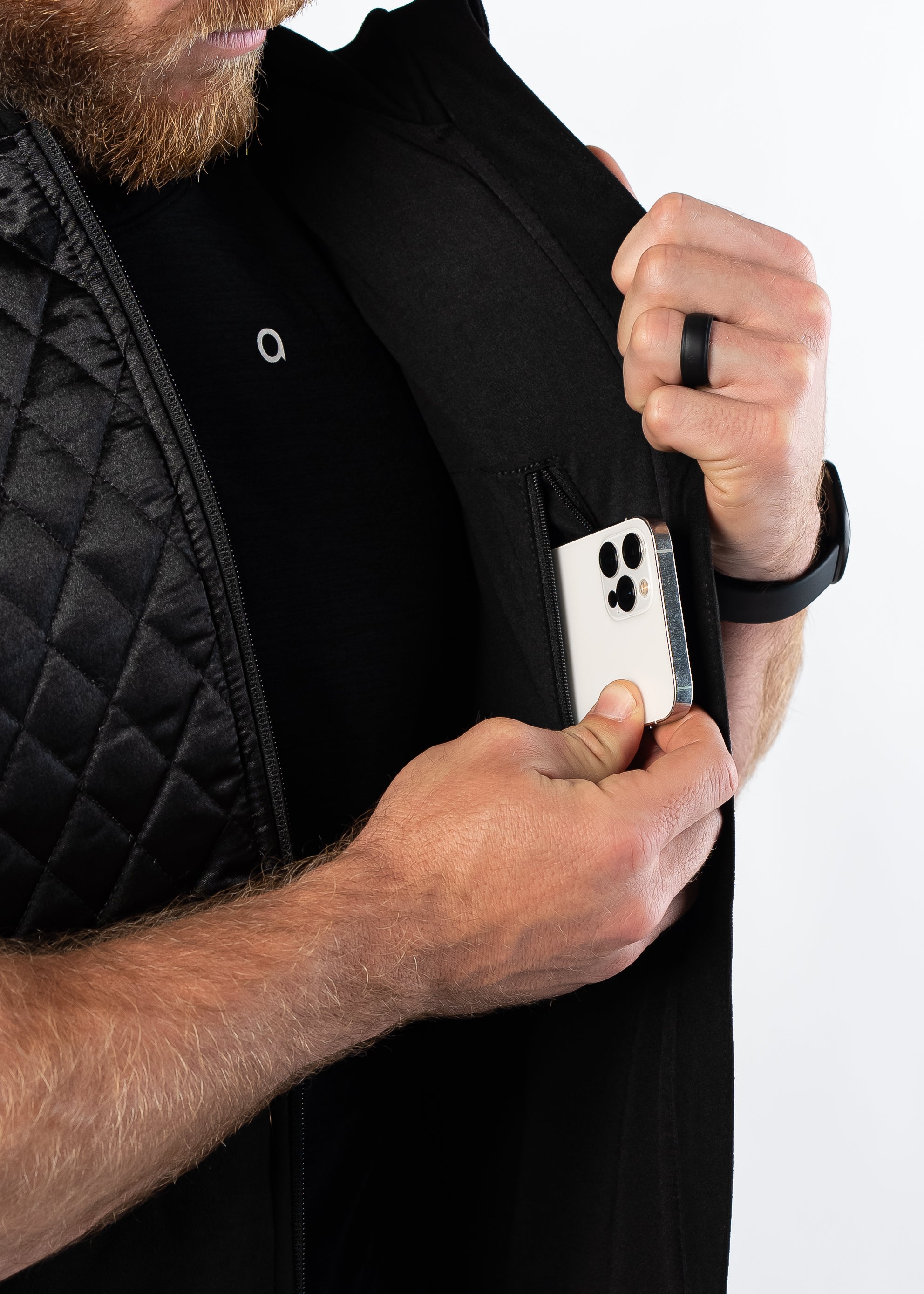 Man pulling out smartphone from interior pocket of Aion Boardroom Recovery Vest in black
