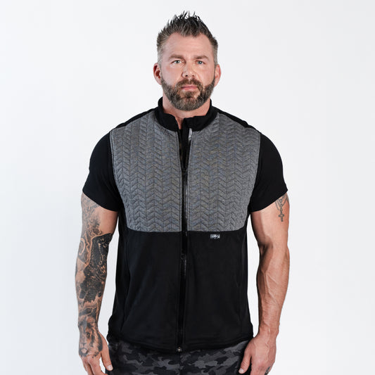 Bearded man wearing Aion Boardroom Recovery Vest in Chevron Gray