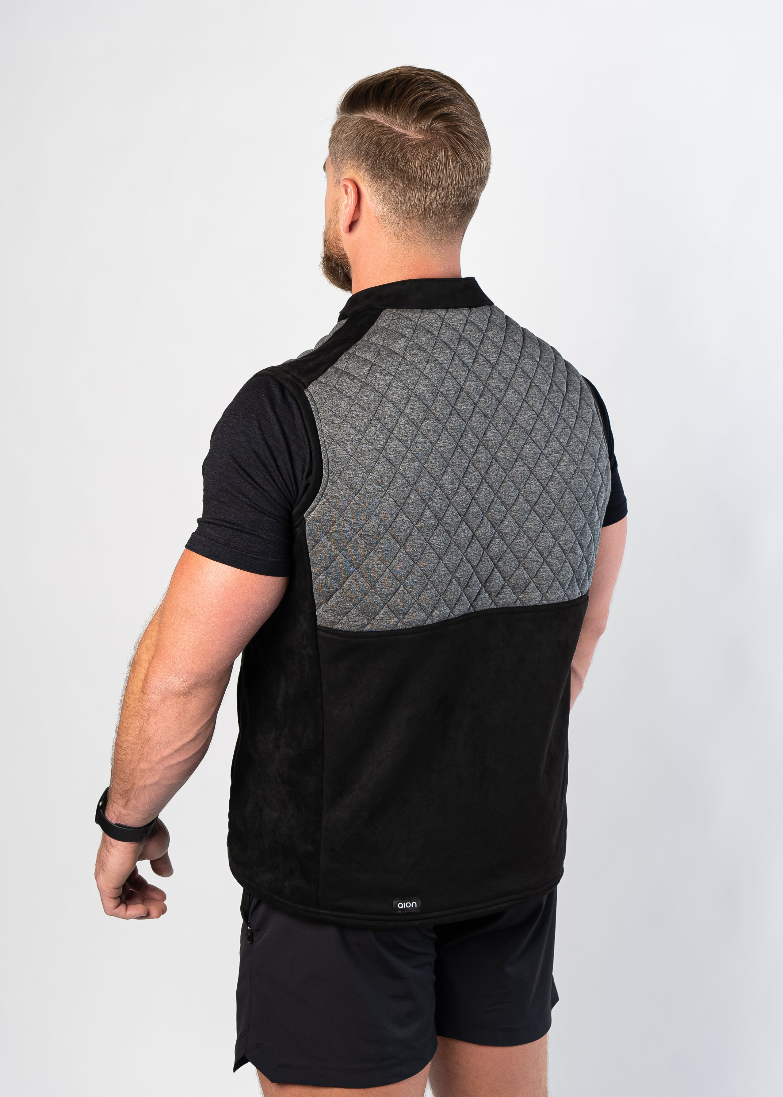 Side view of man wearing Aion Boardroom Recovery Vest in Diamond Gray