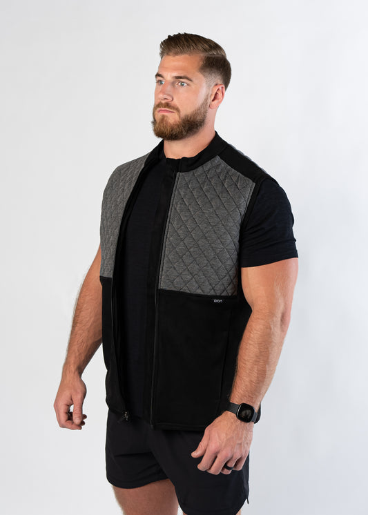 Athletic man in gym shorts showing side view of Aion Boardroom Recovery Vest in Diamond Gray