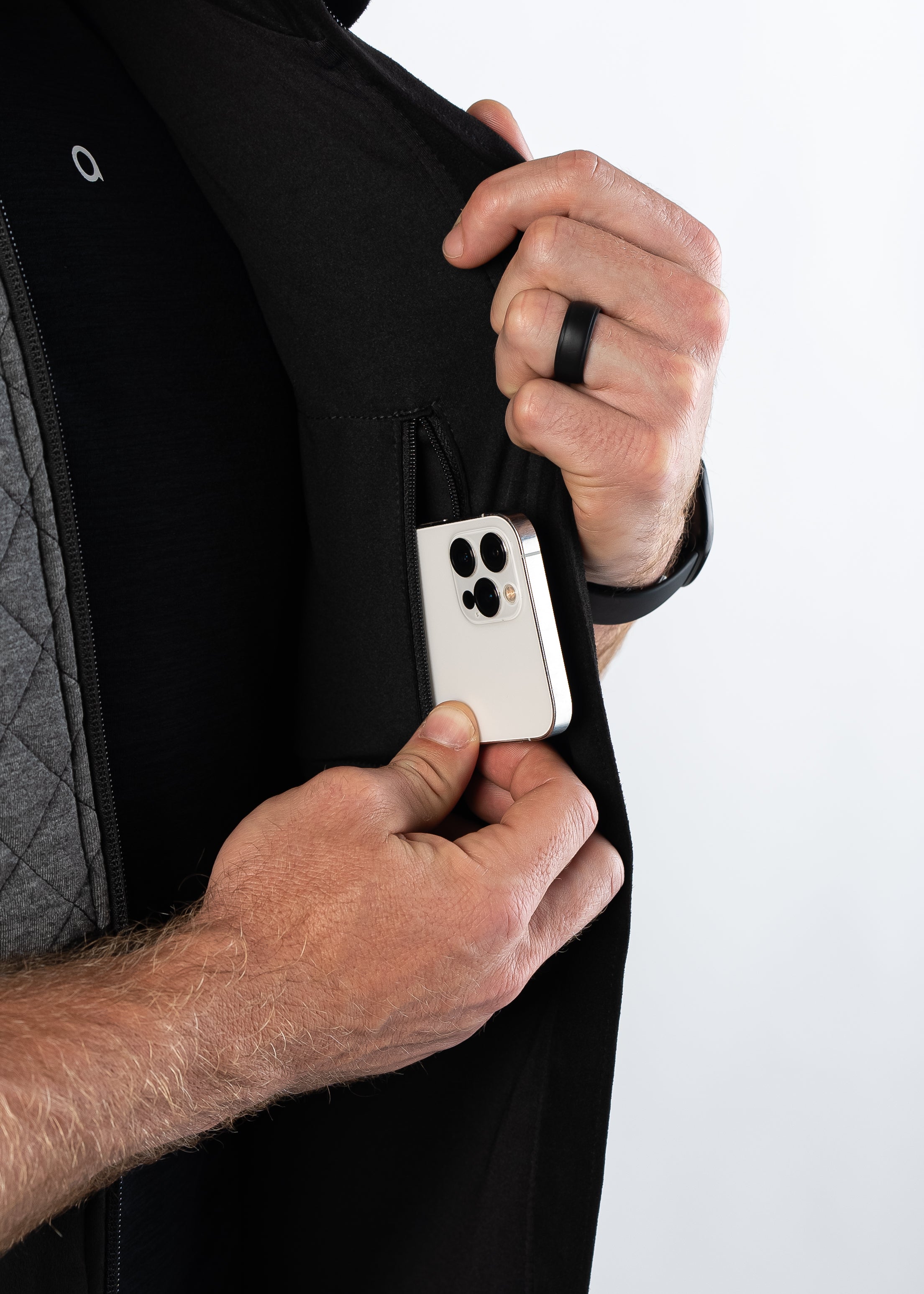 Man pulling out smartphone from interior pocket of Aion Boardroom Recovery Vest in Diamond Gray