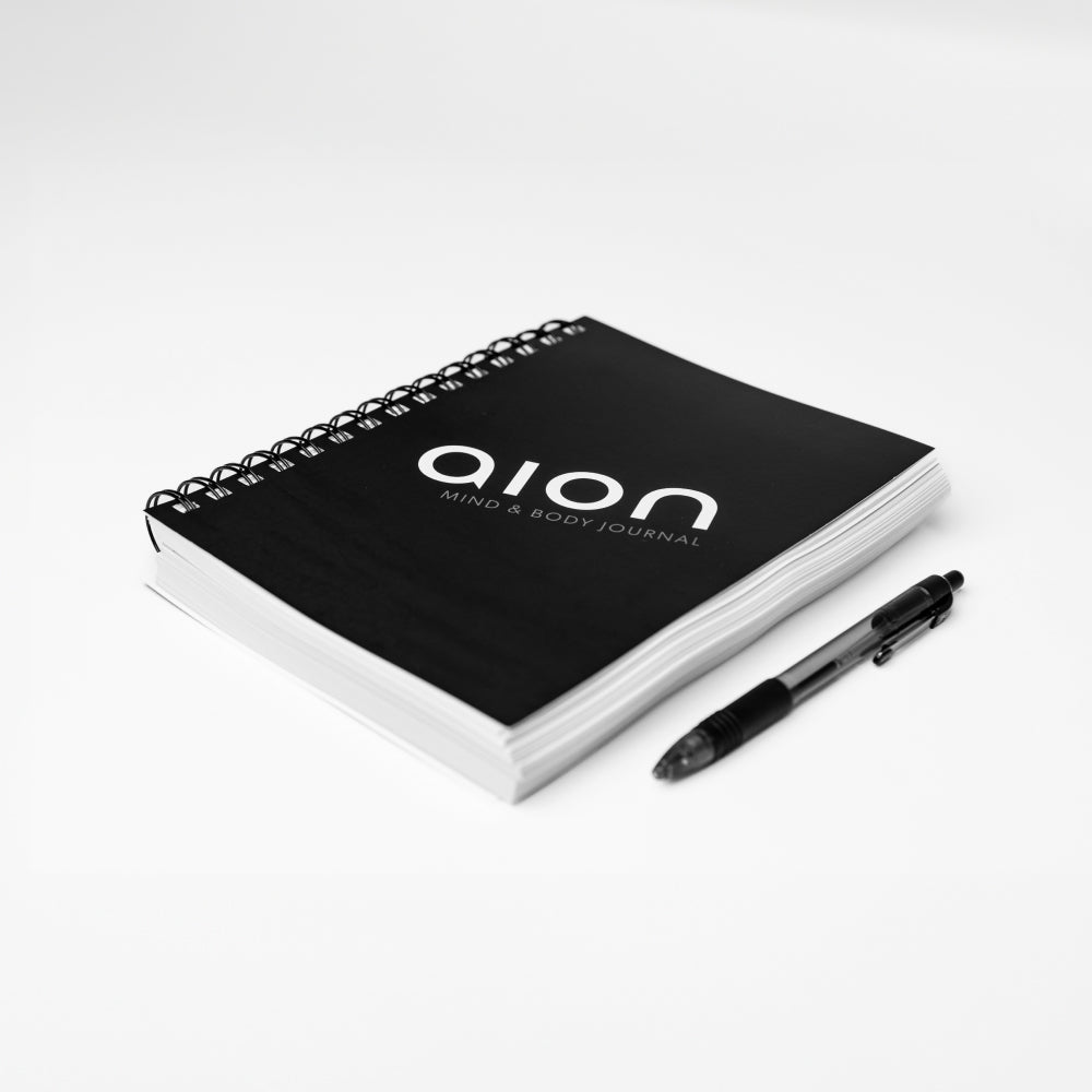 Aion Mind & Body Journal placed next to a pen