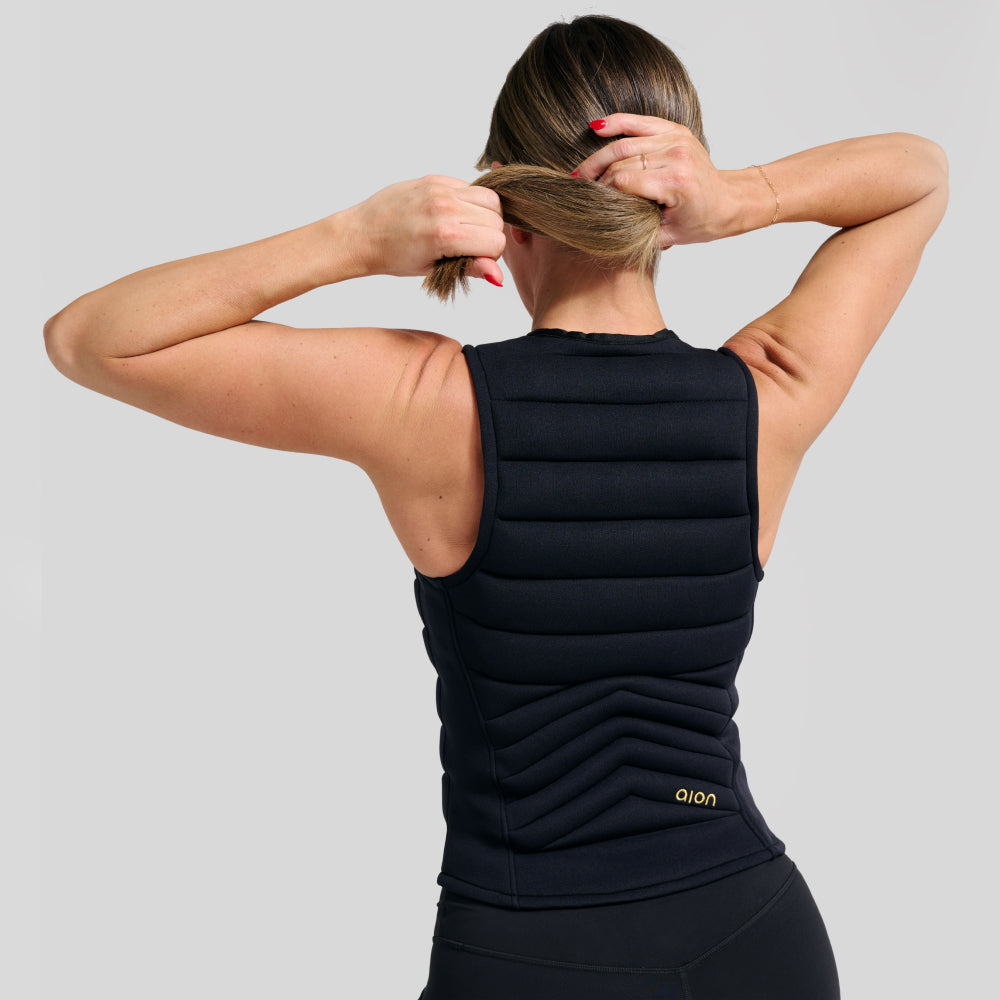 Back view of woman wearing black Aion women’s weighted workout vest | Model: Height: 5'5" Wearing: Size S