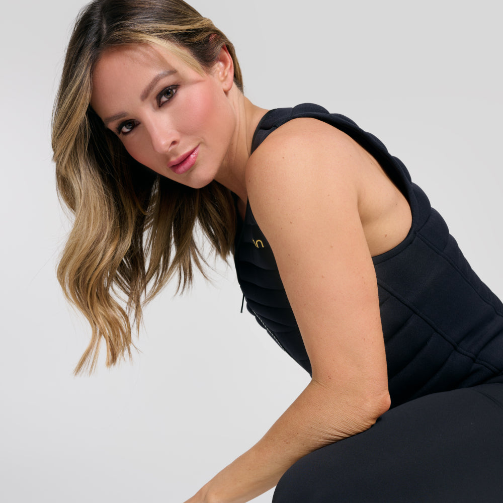 Side view of woman showing shoulder straps on black Aion weighted vest | Model: Height: 5'5" Wearing: Size S