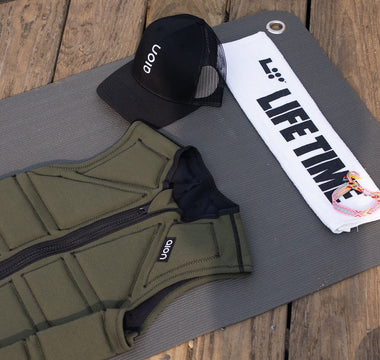 Aion men's weighted vest on a Life Time fitness mat with a Life Time towel and an Aion hat at Life Time MB360 class