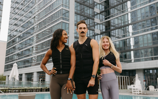 Three individuals wearing Aion weighted vests pose poolside in an urban setting, showcasing functional fitness, strength training, and active lifestyle performance.