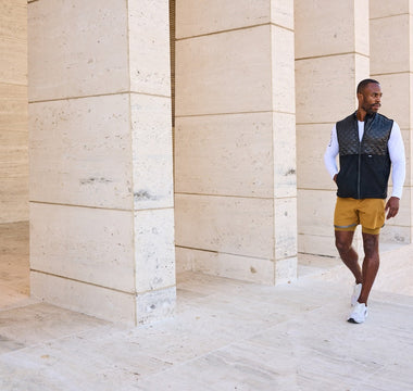 Man walking casually wearing Aion boardroom recovery vest in black