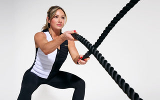 World-renowned fitness cover model, entrepreneur, and social media star Paige Hathaway wearing the Aion Women's Weighted Vest while throwing a weighted rope