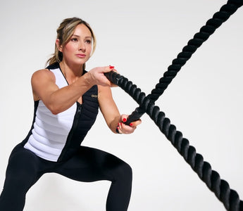 World-renowned fitness cover model, entrepreneur, and social media star Paige Hathaway wearing the Aion Women's Weighted Vest while throwing a weighted rope