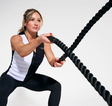 World-renowned fitness cover model, entrepreneur, and social media star Paige Hathaway wearing the Aion Women's Weighted Vest while throwing a weighted rope