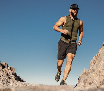 Man running outdoors wearing Limited Edition Aion green men's weighted vest