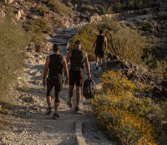 Three men rucking outdoors wearing Aion weighted vests for Zone 2 cardio training