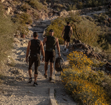 Three men rucking outdoors wearing Aion weighted vests for Zone 2 cardio training