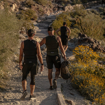Three men rucking on a mountain road wearing Aion weighted vests