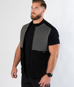 Athletic man in gym shorts showing side view of Aion Boardroom Recovery Vest in Diamond Gray