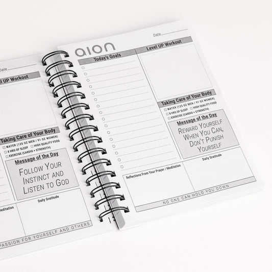 Open Aion Mind & Body Journal showing inner pages
