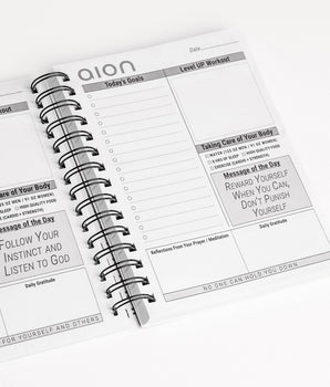 Open Aion Mind & Body Journal showing inner pages